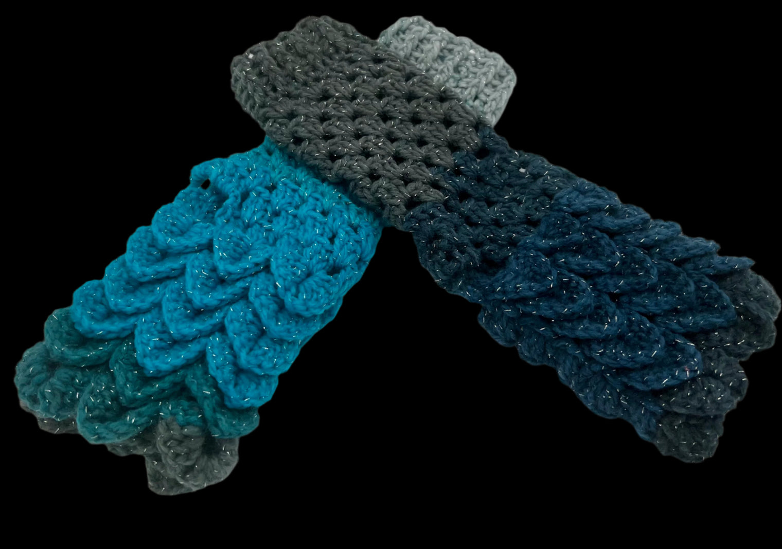 A pair of crochet fingerless gloves using the crocodile stitch. The color is blues and greys, nicknamed Stardust.